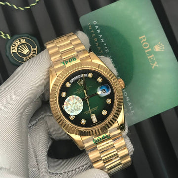 Rolex day date green in gold strap