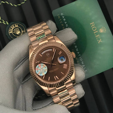 Rolex day date chocolate in rose gold strap roman dial